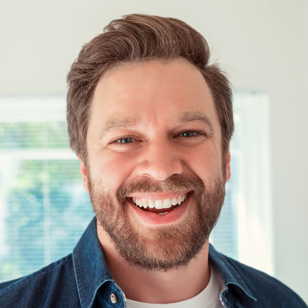 Close-up portrait of happy mid adult man at home