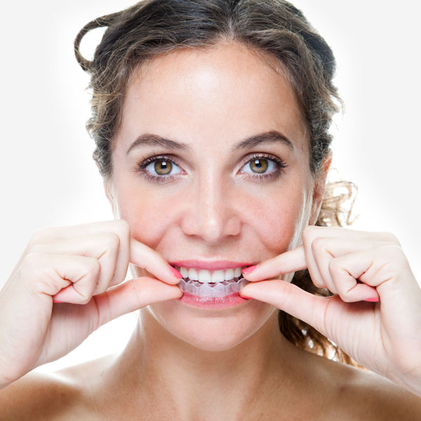 Close-up of young woman wearing clear braces