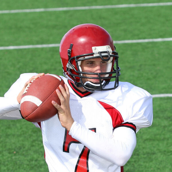 High school football player on the field about to make a pass